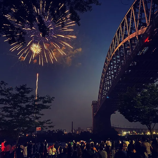 Fireworks over the East River near the Hell Gate Bridge in Astoria, Queens, New York City.